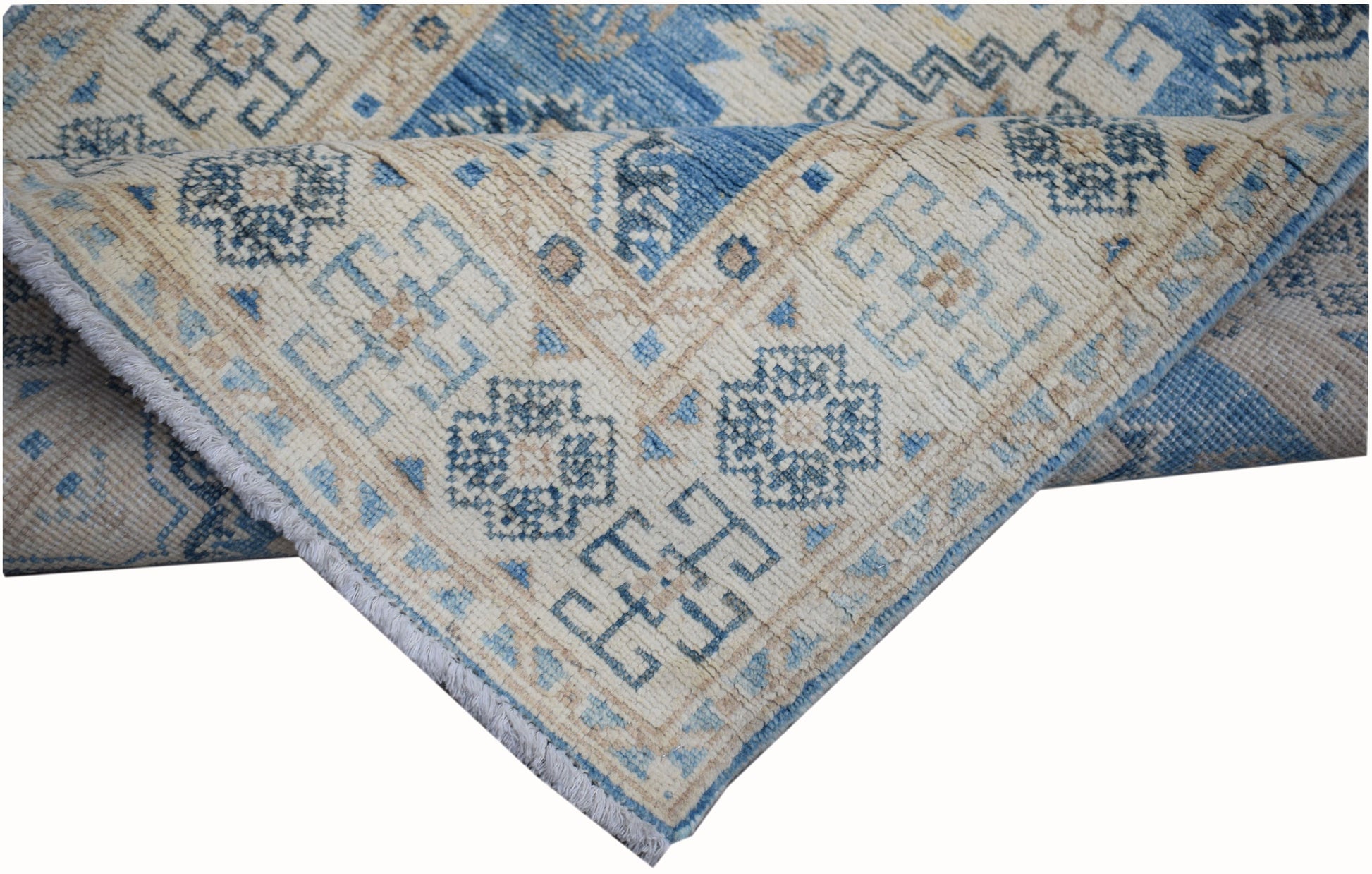 A handmade Afghan Kazakh runner rug featuring a geometric pattern in shades of blue and beige.