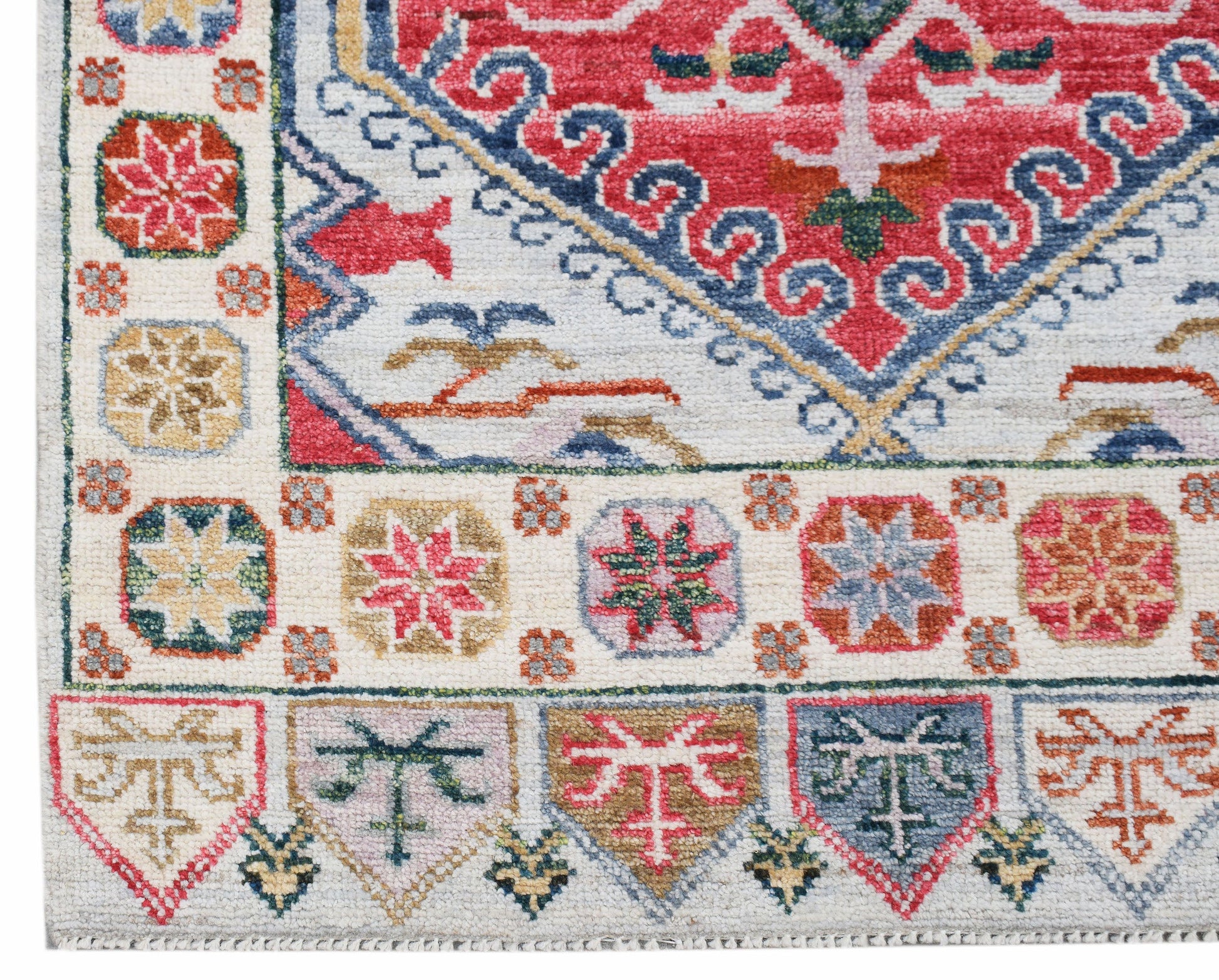 A handwoven wool runner featuring a transitional Oushak pattern in vibrant, multi-colored tones.