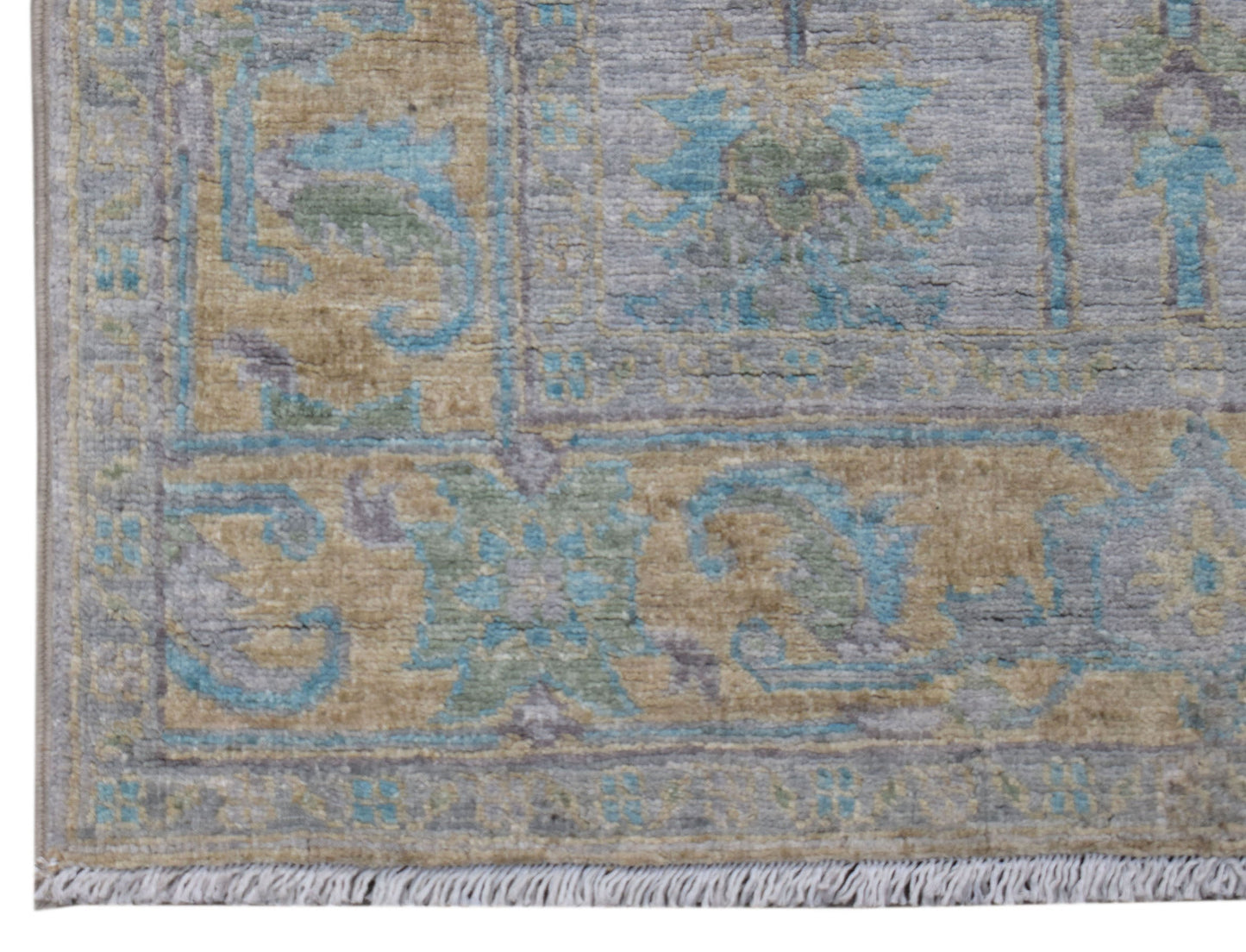 A transitional Oushak runner featuring a floral pattern in muted blue, tan, and grey tones.