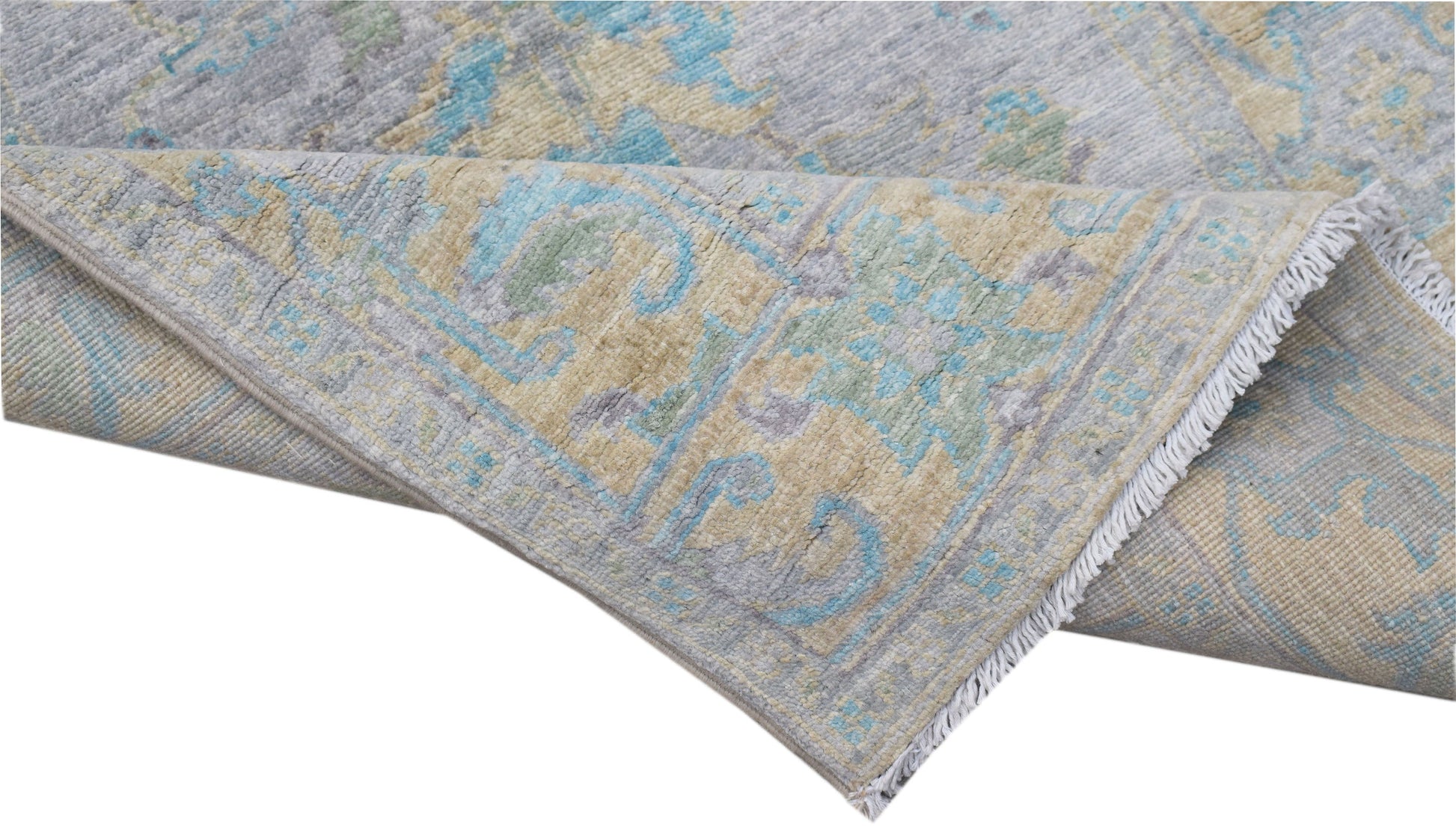 A handwoven transitional Oushak runner featuring a floral pattern in blue, grey, and beige tones.