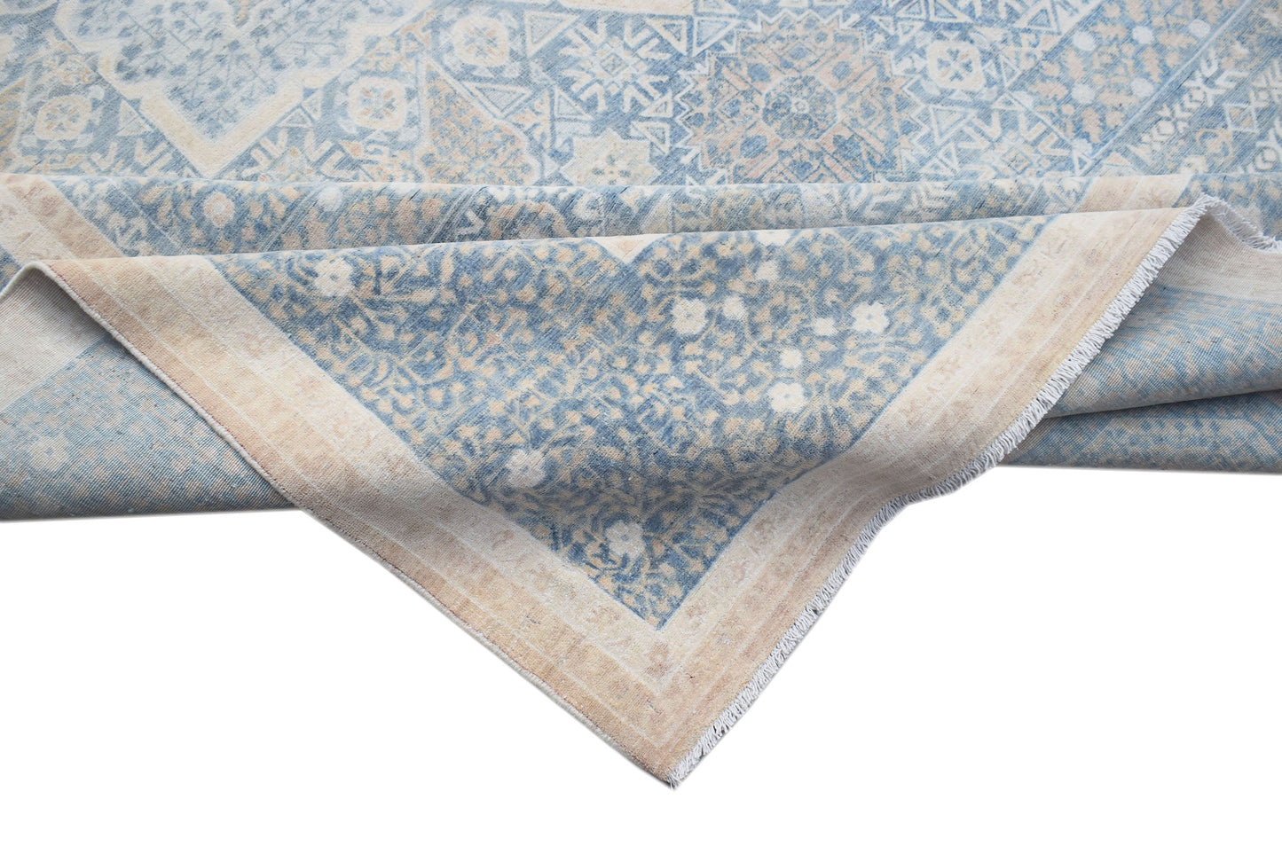 A handwoven Afghan Balkh rug featuring a blue and beige Mamluk pattern with a fringed edge.