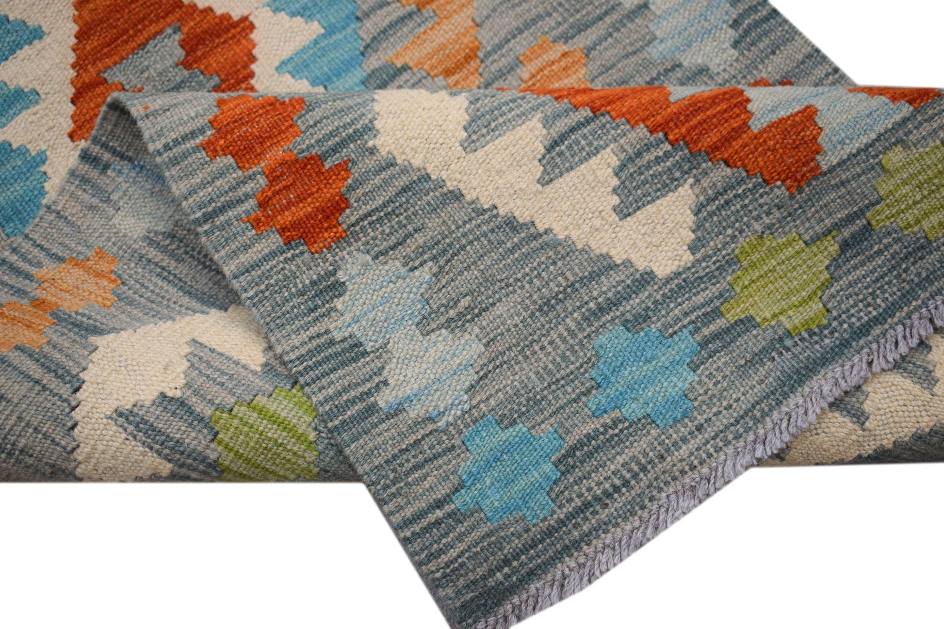 A handmade Afghan Maimana wool runner rug featuring a geometric pattern in blue, orange, and green.