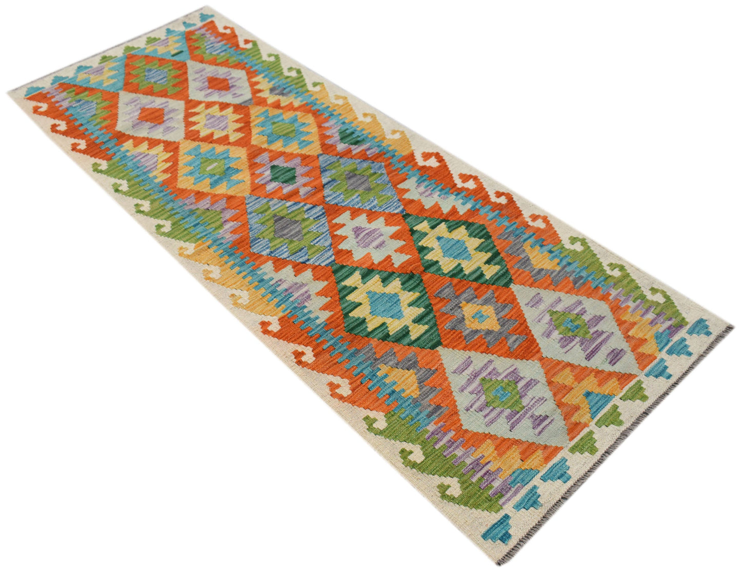 A handmade Afghan Maimana wool runner rug featuring a vibrant geometric diamond pattern.