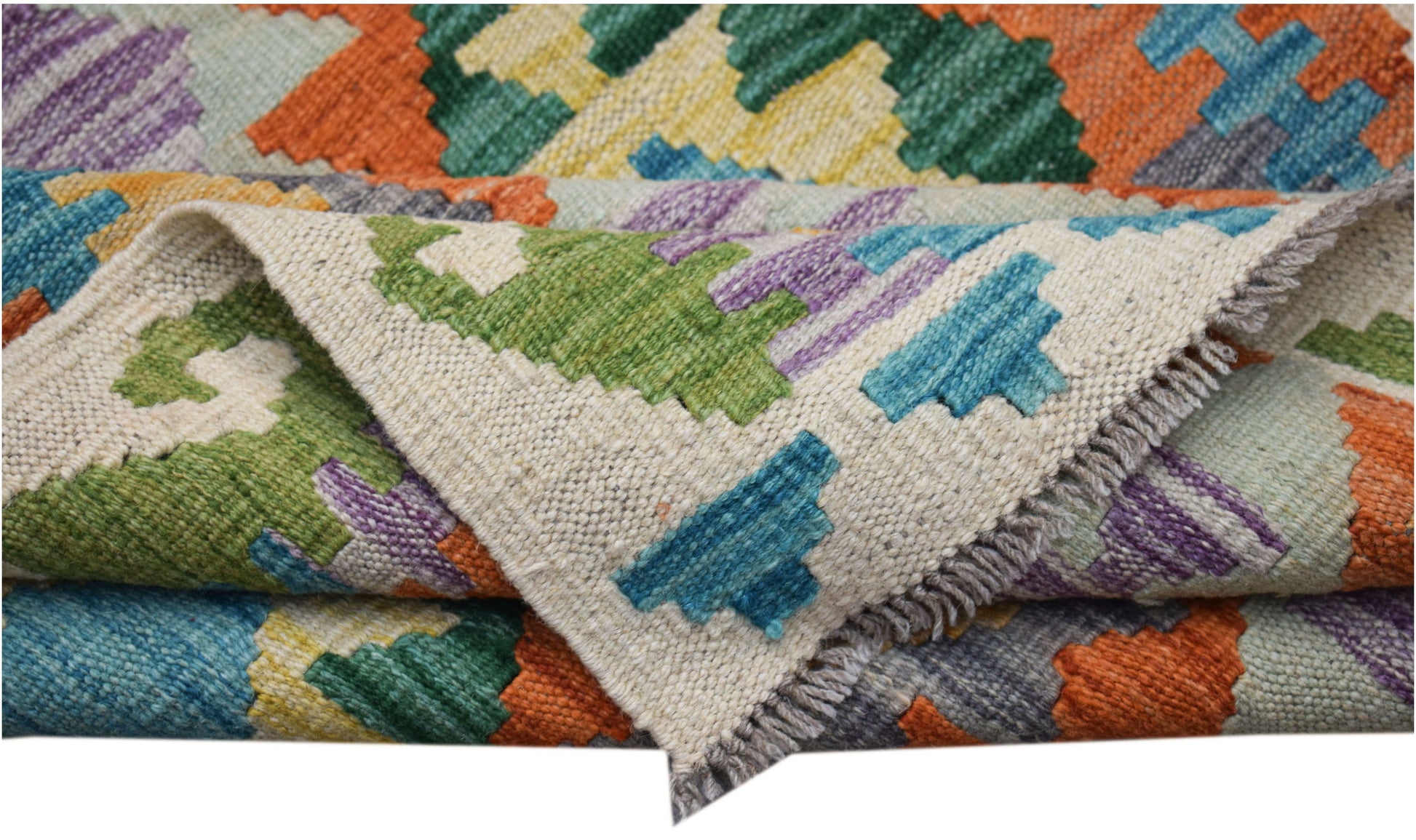 A handwoven Afghan Maimana kilim runner featuring a colorful geometric pattern in wool.