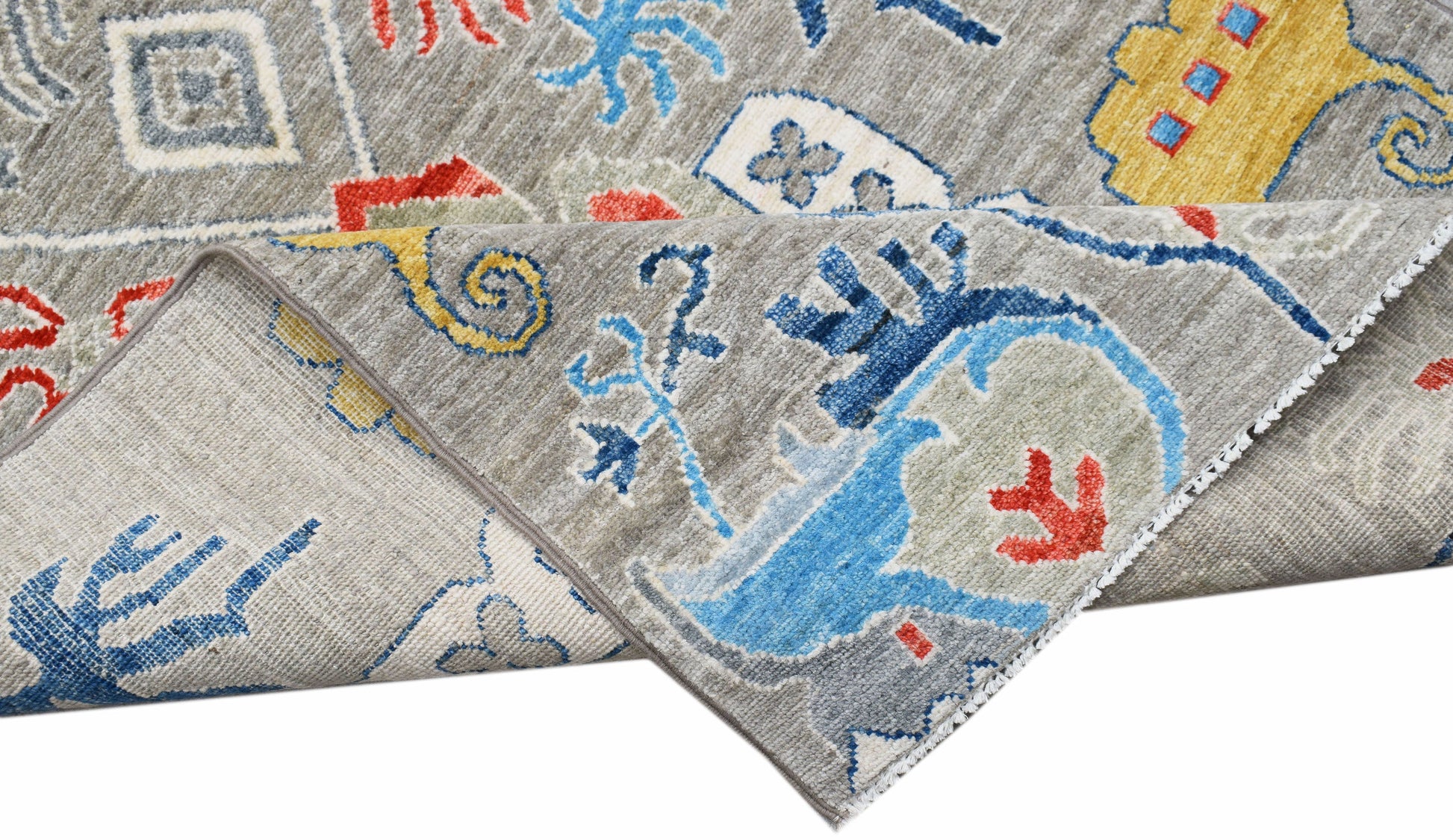 A handmade Afghan Chobi runner featuring a grey background with colorful, traditional patterns.