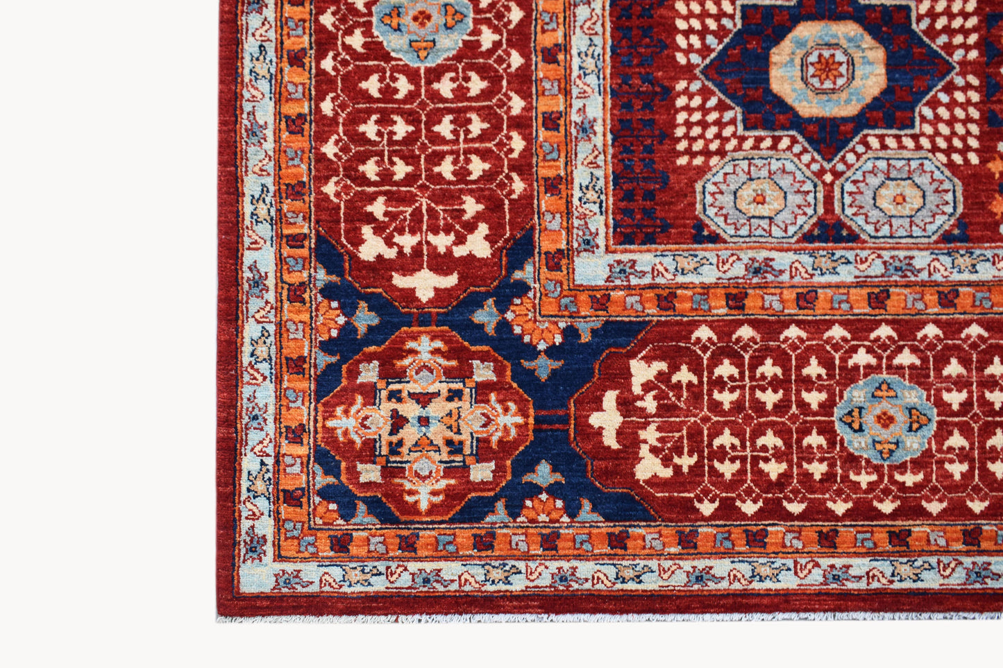 A handmade Afghan Chobi rug featuring a traditional Mamluk pattern in red, blue, and orange tones.