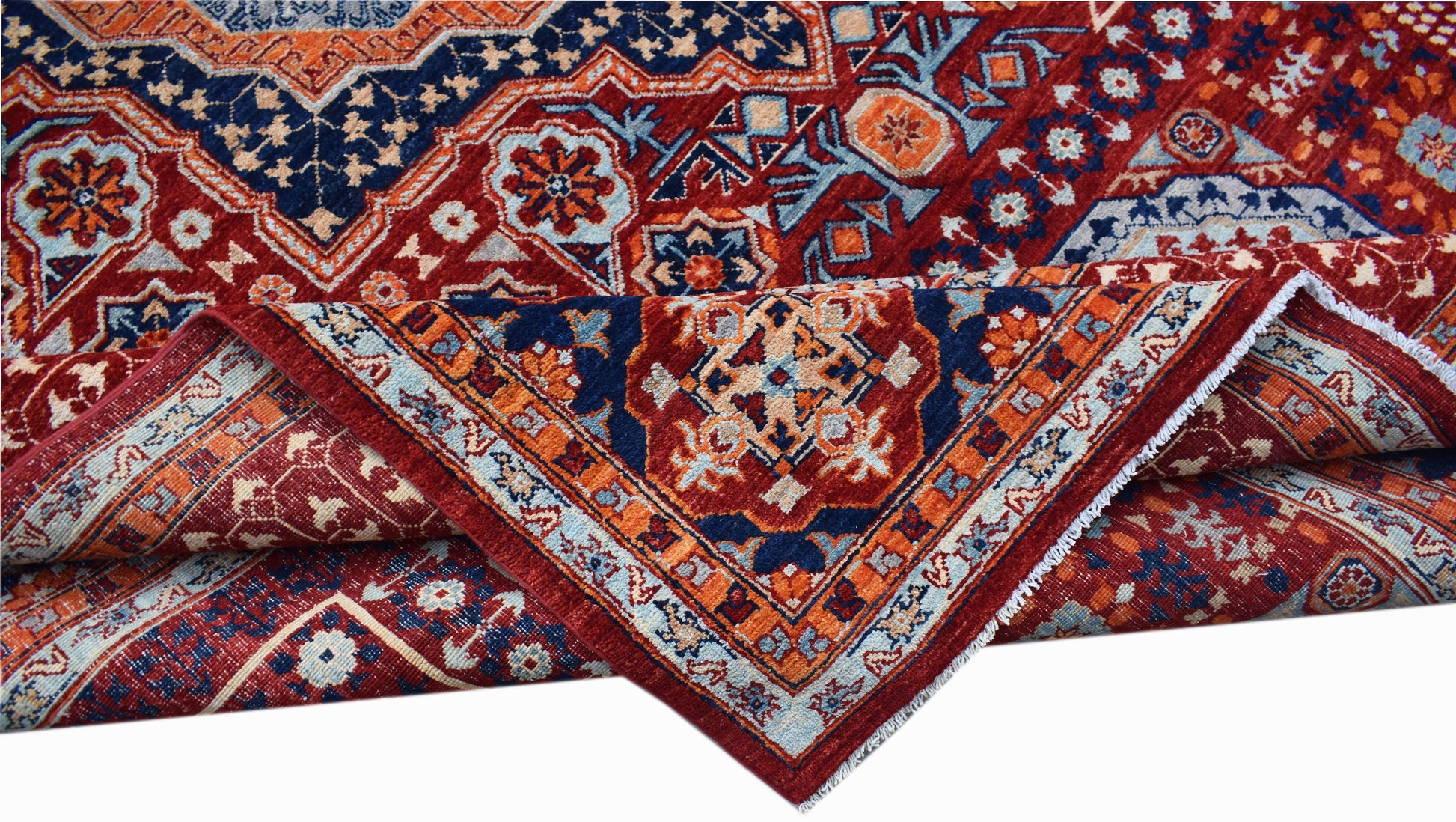 A handwoven Afghan Chobi rug featuring a complex Mamluk medallion pattern in red, blue, and cream.