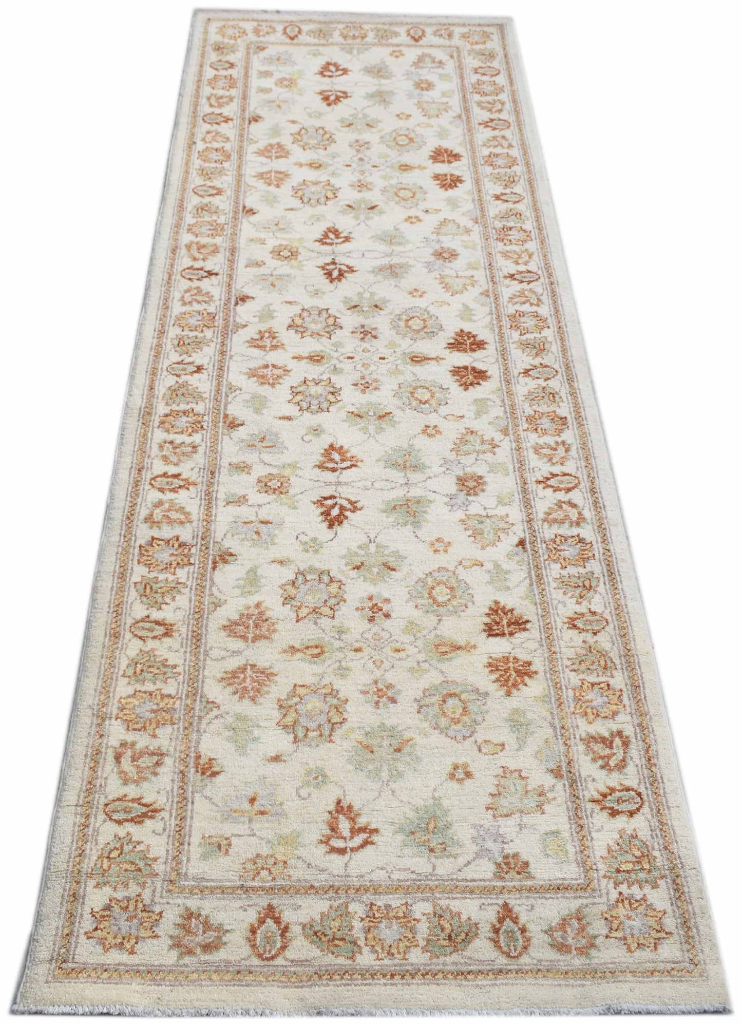 A handmade Afghan Chobi runner rug featuring a traditional floral pattern in soft earth tones.