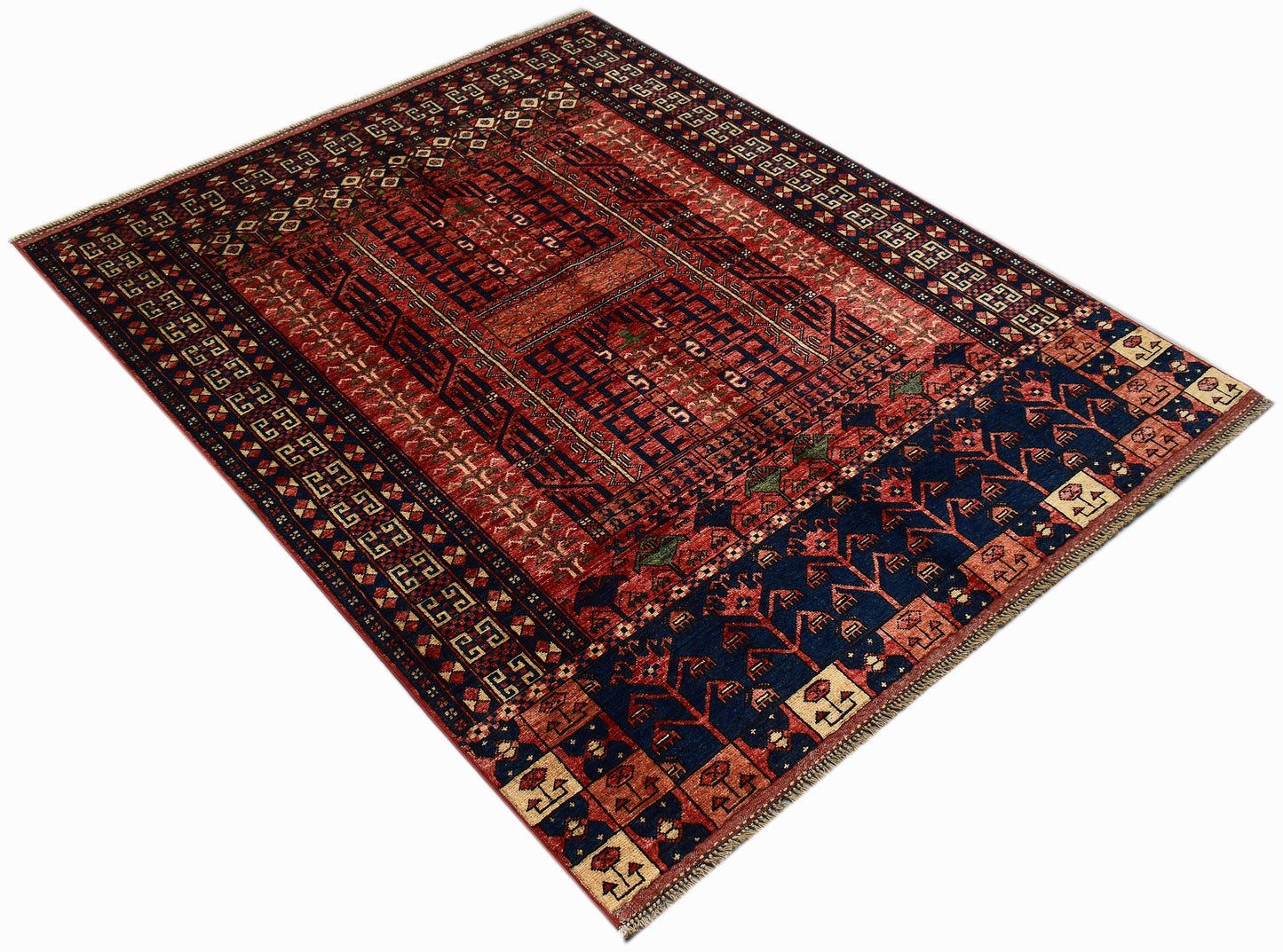 A handmade Afghan Chobi rug featuring a geometric pattern in deep red and blue tones.