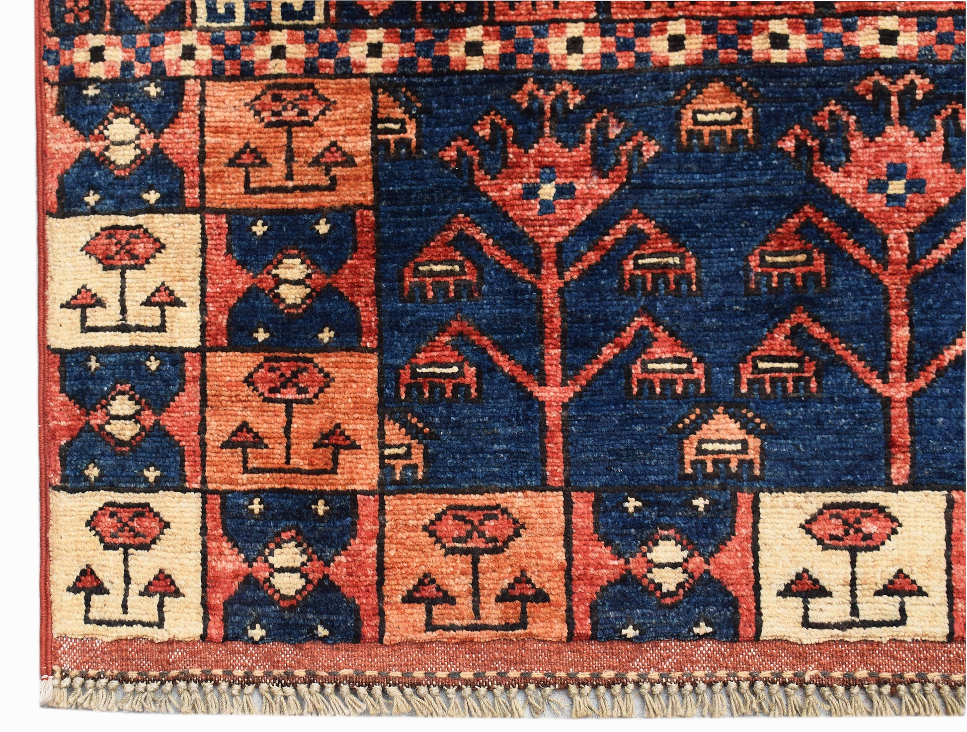 A handwoven Afghan Chobi rug featuring a geometric grid pattern in blue, orange, and cream tones.