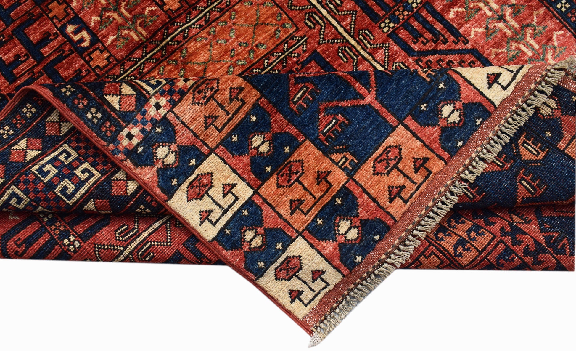 A handwoven Afghan Chobi rug featuring a geometric grid pattern in shades of red, blue, and cream.