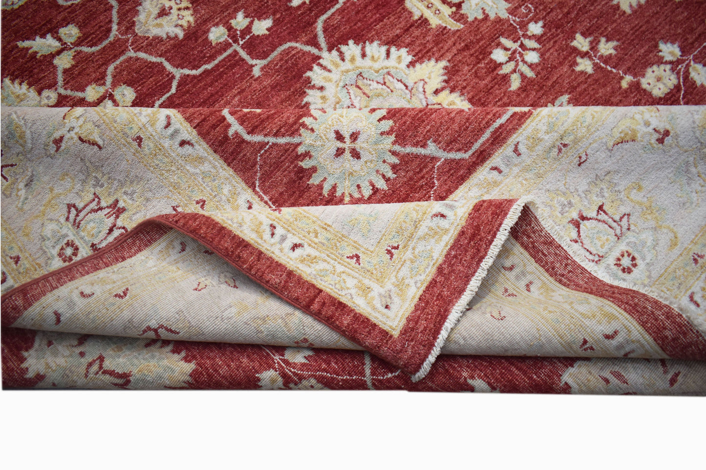 A handwoven Afghan Chobi rug featuring a traditional floral pattern in shades of red and cream.