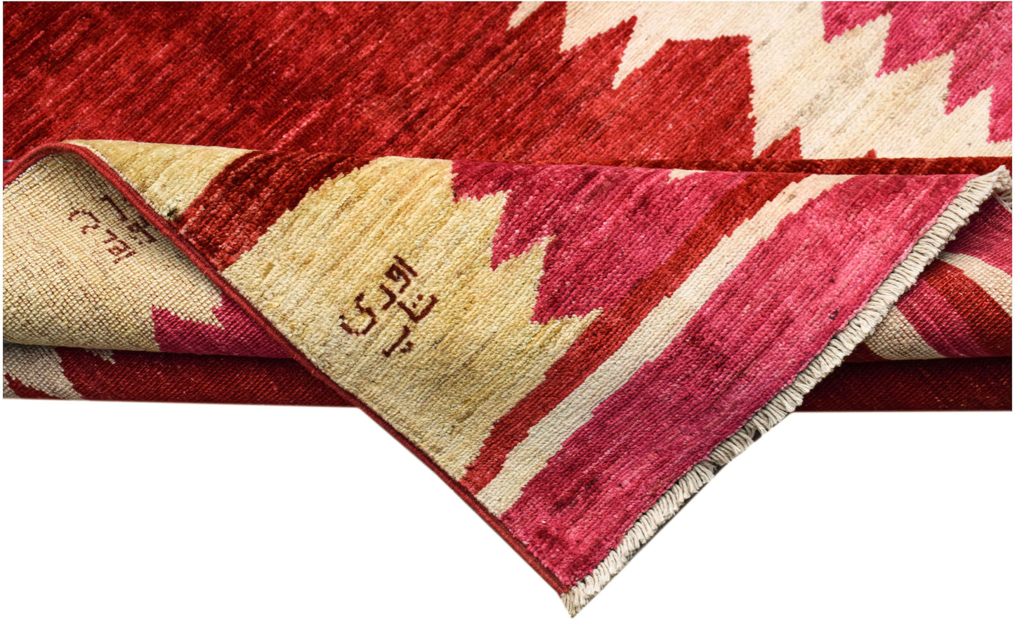 A handmade Afghan Gabbeh rug featuring a geometric pattern in shades of red and cream.