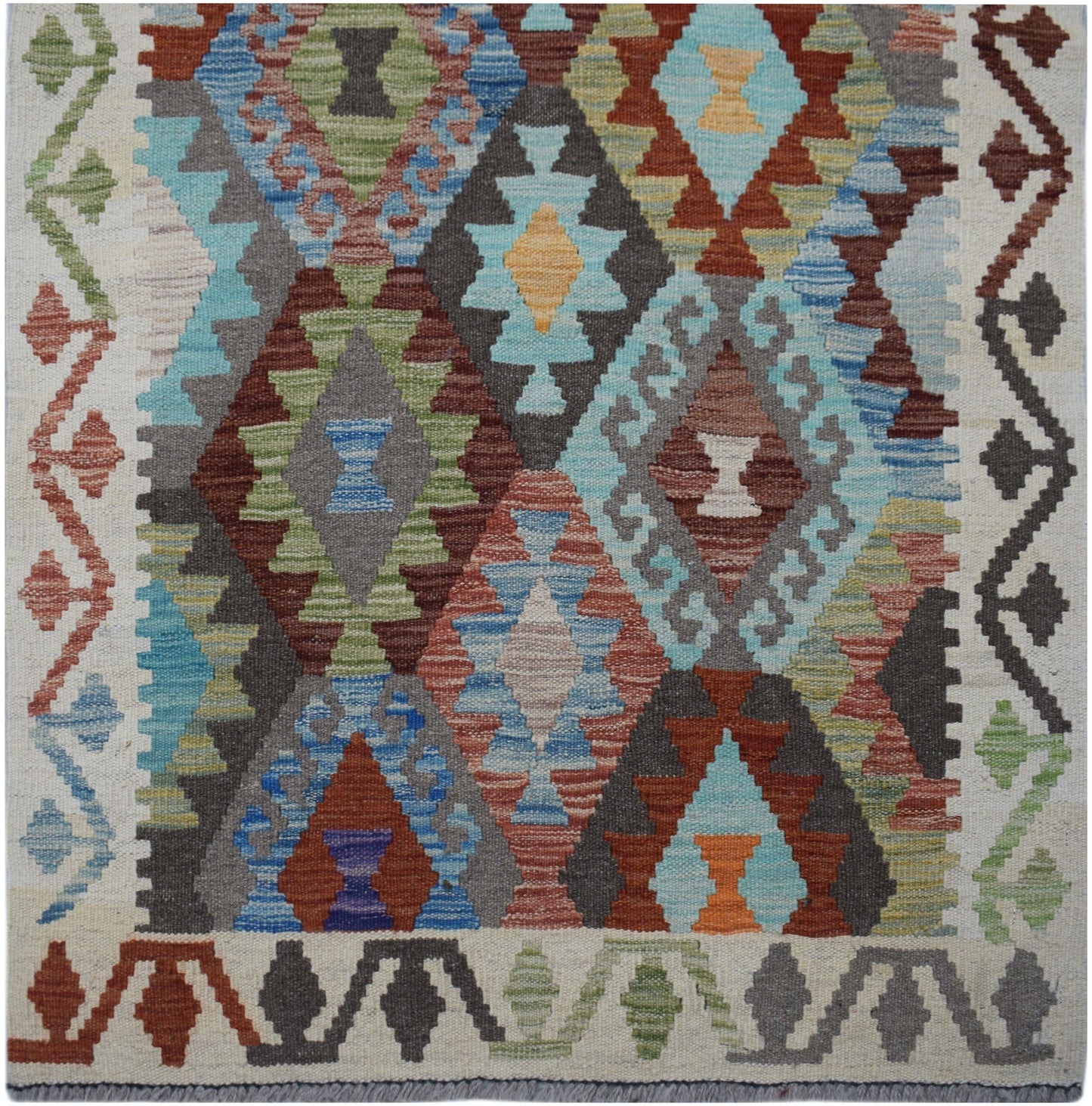 Handwoven Afghan Maimana wool runner featuring a colorful geometric diamond pattern.