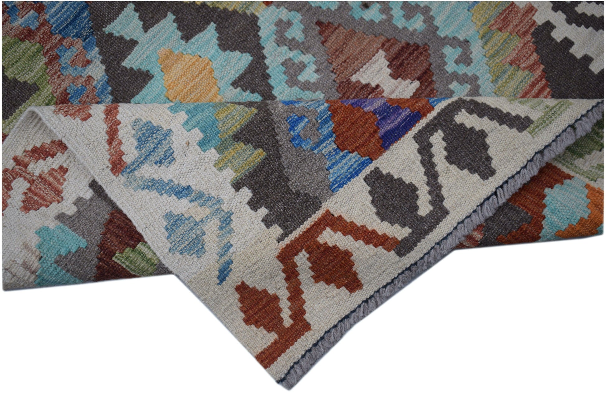 A handmade Afghan Maimana kilim runner featuring a geometric pattern in vibrant wool colors.