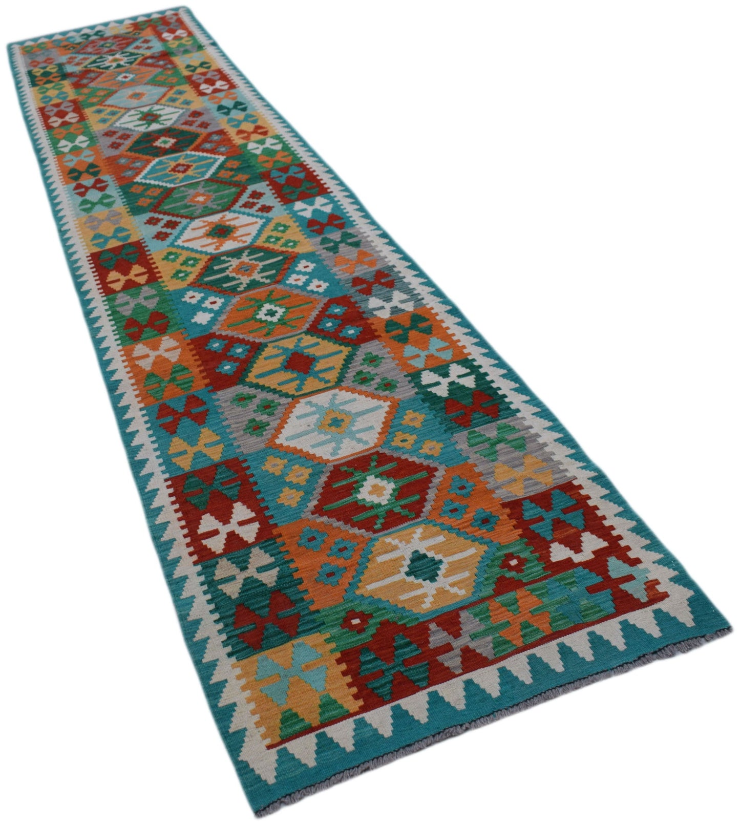 A handmade Afghan Maimana wool runner rug featuring a colorful geometric pattern.