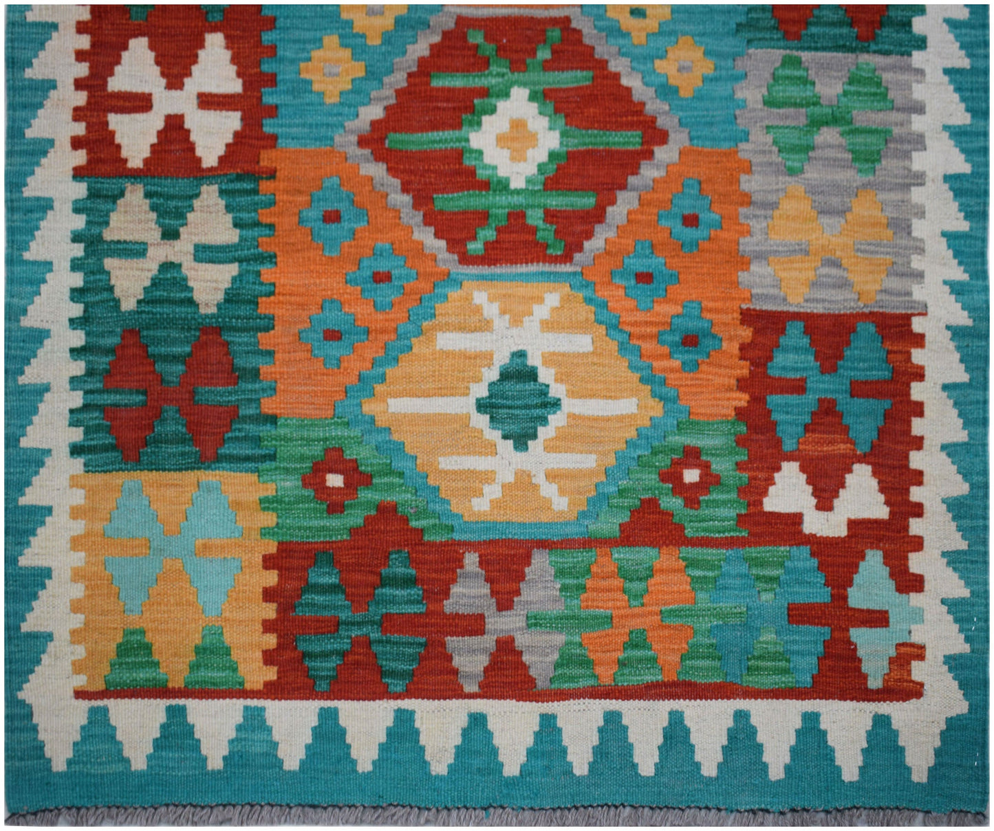 Handwoven Afghan Maimana wool runner featuring a vibrant geometric pattern in multi-colored blocks.