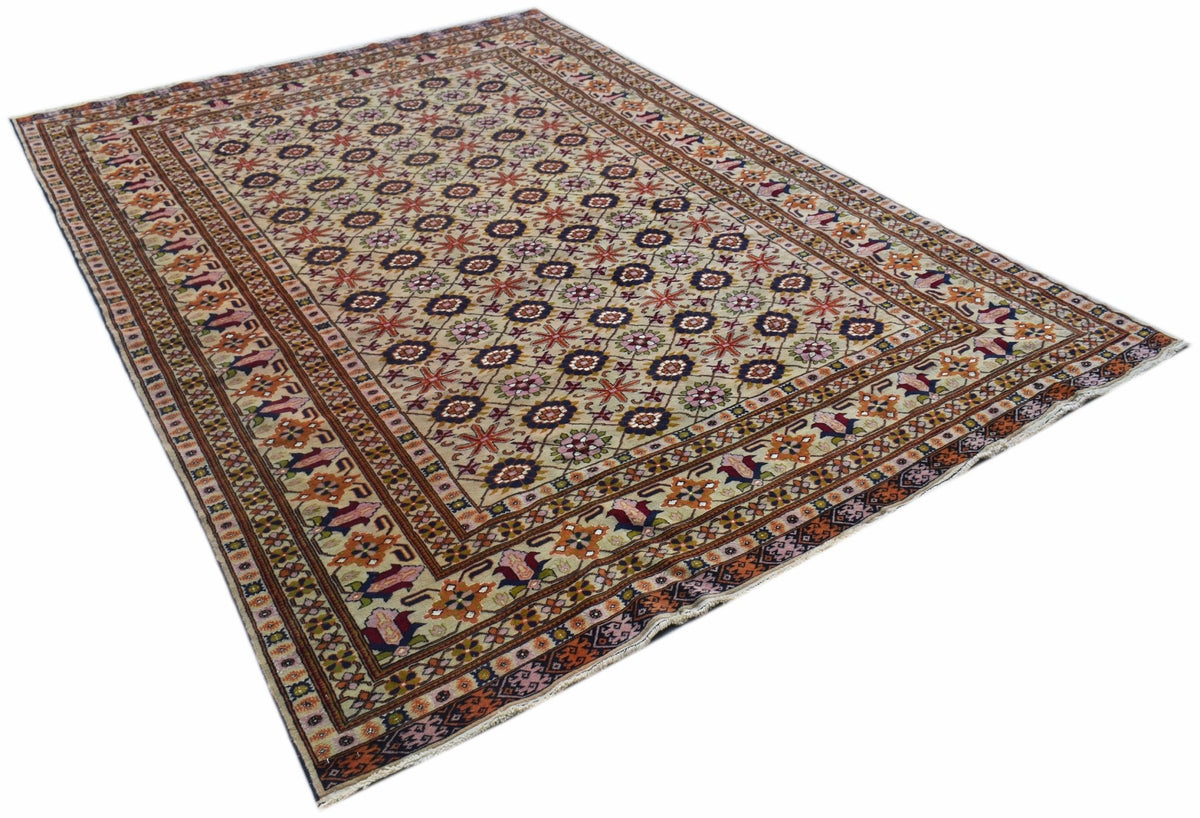 A hand-knotted Afghan Bashiri rug featuring a repeating geometric floral pattern in silk and wool.