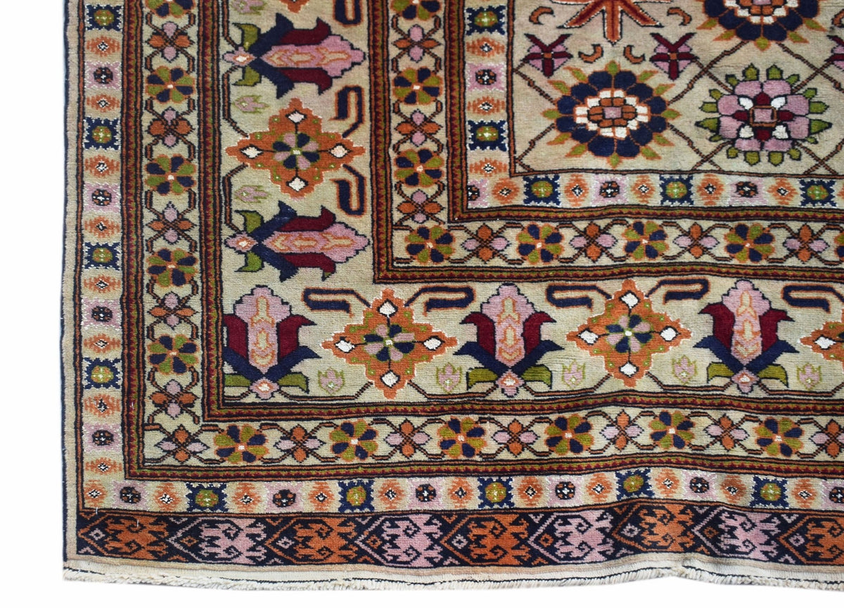 A hand-knotted Afghan Bashiri rug featuring intricate geometric floral patterns in silk and wool.