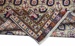 A hand-knotted Afghan Bashiri rug featuring intricate floral patterns in silk and wool.