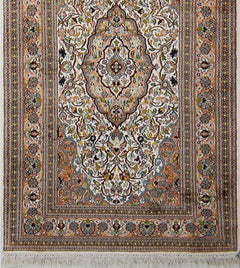 A handmade Kashmiri silk runner featuring an intricate floral Persian pattern in soft pastel tones.