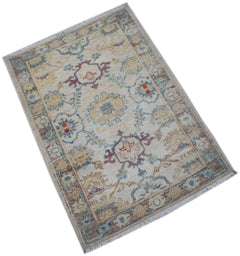A handmade Afghan Chobi rug featuring a traditional floral pattern in blue, red, and beige tones.