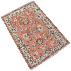 Handmade Afghan Chobi rug featuring a floral pattern in shades of terracotta, cream, and blue.