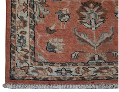 A handmade Afghan Chobi rug featuring a floral pattern in shades of terracotta, cream, and blue.