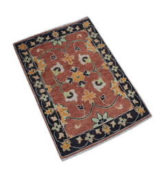 A rectangular handmade Afghan Chobi rug featuring a floral pattern in rust, yellow, and green.