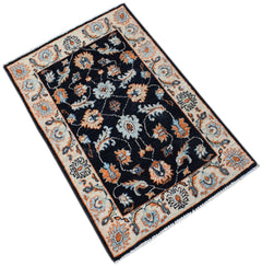 A handmade Afghan Chobi rug featuring a dark blue field with floral patterns in orange and cream.