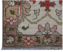 A handmade Afghan Chobi rug featuring a floral pattern in red, grey, and green on a cream field.