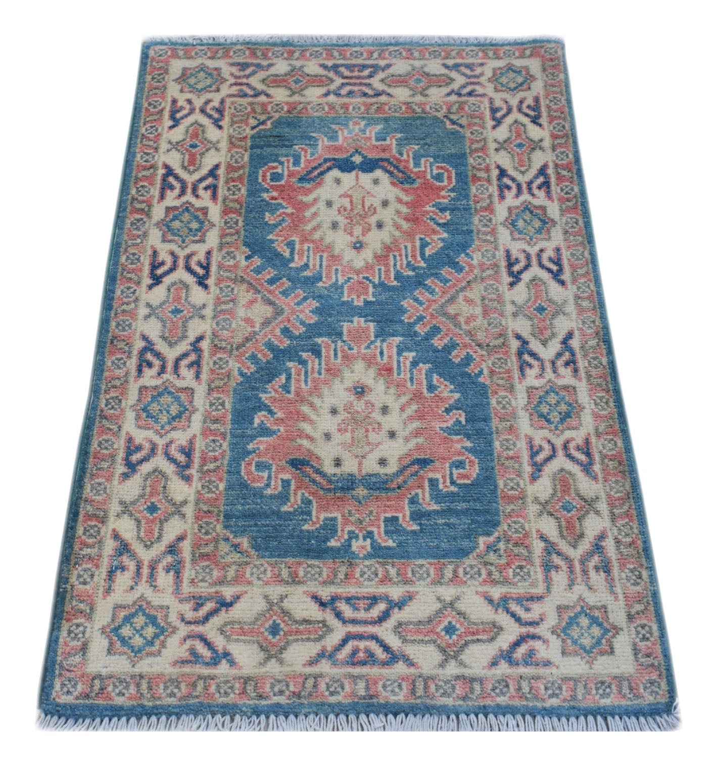 A handmade wool Afghan Kazakh rug featuring a blue field with pink and cream geometric medallions.