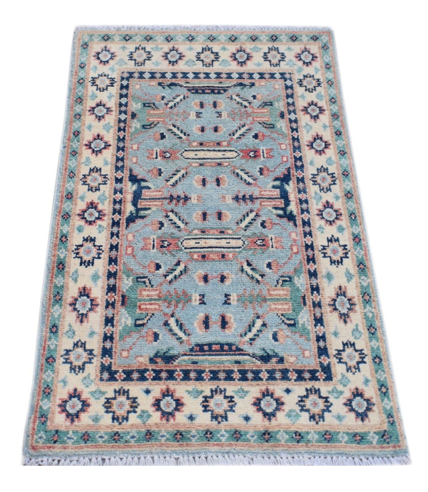 A handmade Afghan Kazakh rug featuring a light blue field with geometric patterns and cream borders.
