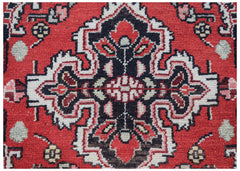 A vintage Persian Sarouk rug featuring a central floral medallion on a red wool background.