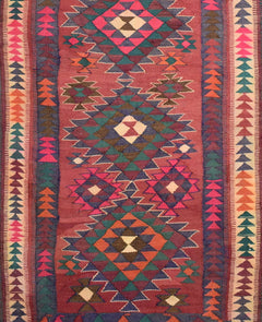 Handmade Persian tribal kilim rug featuring a geometric pattern in red, orange, and teal wool.