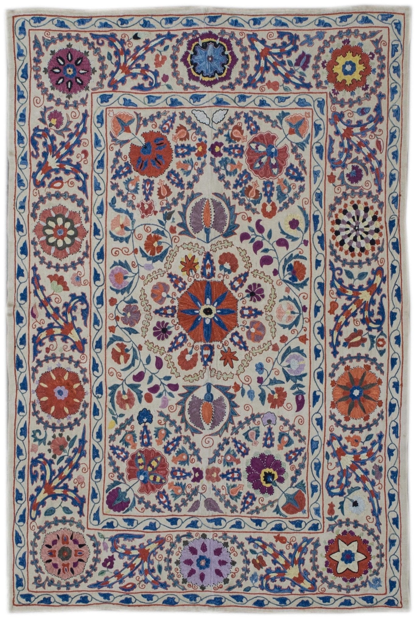 Handmade Uzbek suzani featuring intricate silk floral embroidery on a cream silk fabric base.