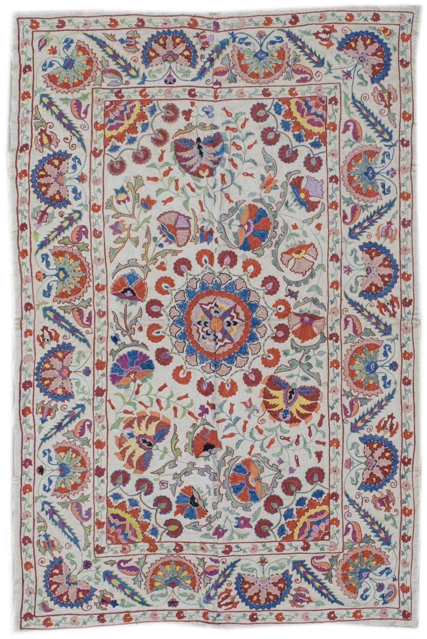 Handmade Uzbek suzani featuring colorful silk floral embroidery on a white silk fabric base.
