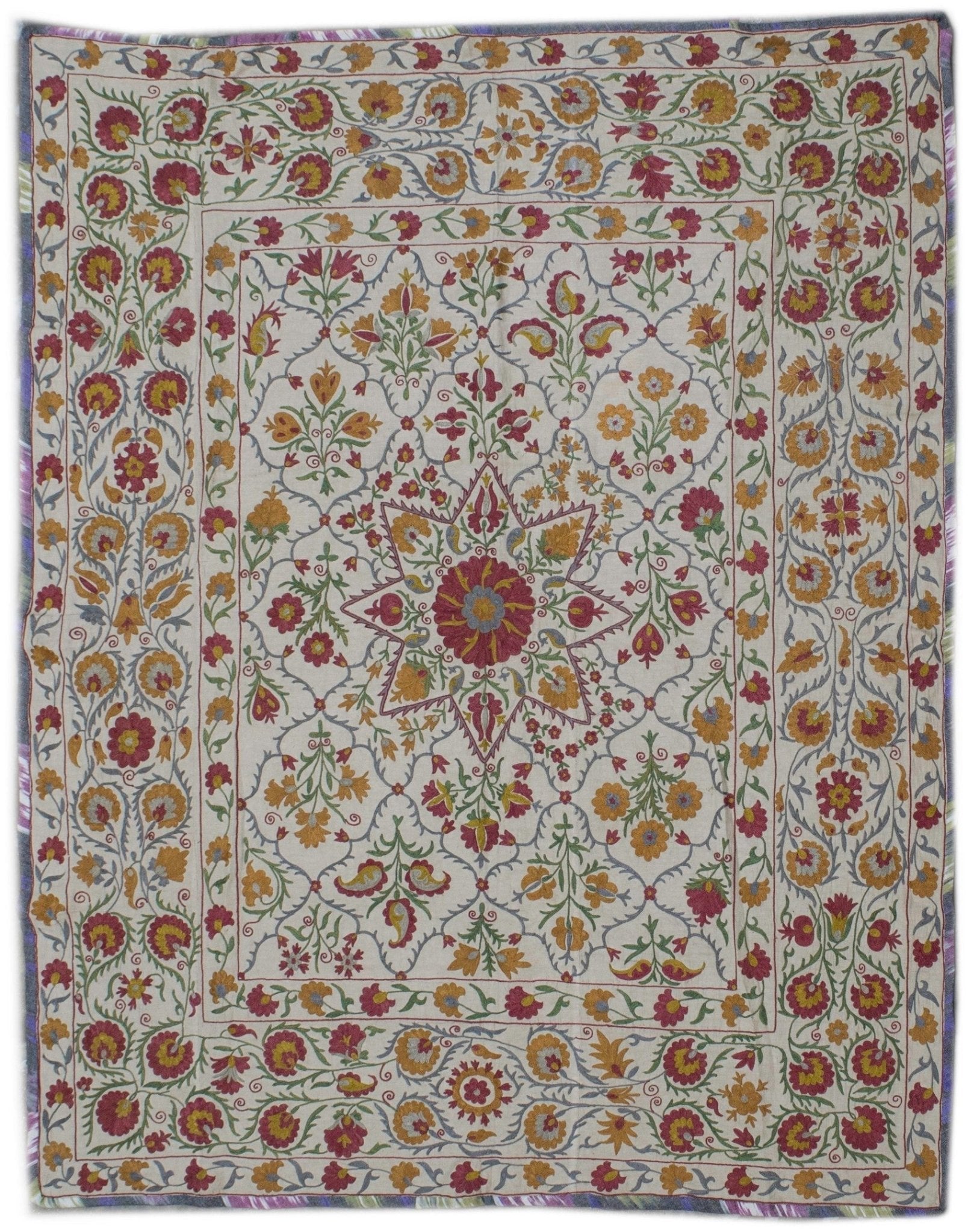 Handmade Uzbek suzani featuring intricate floral silk embroidery on a cream cotton base.