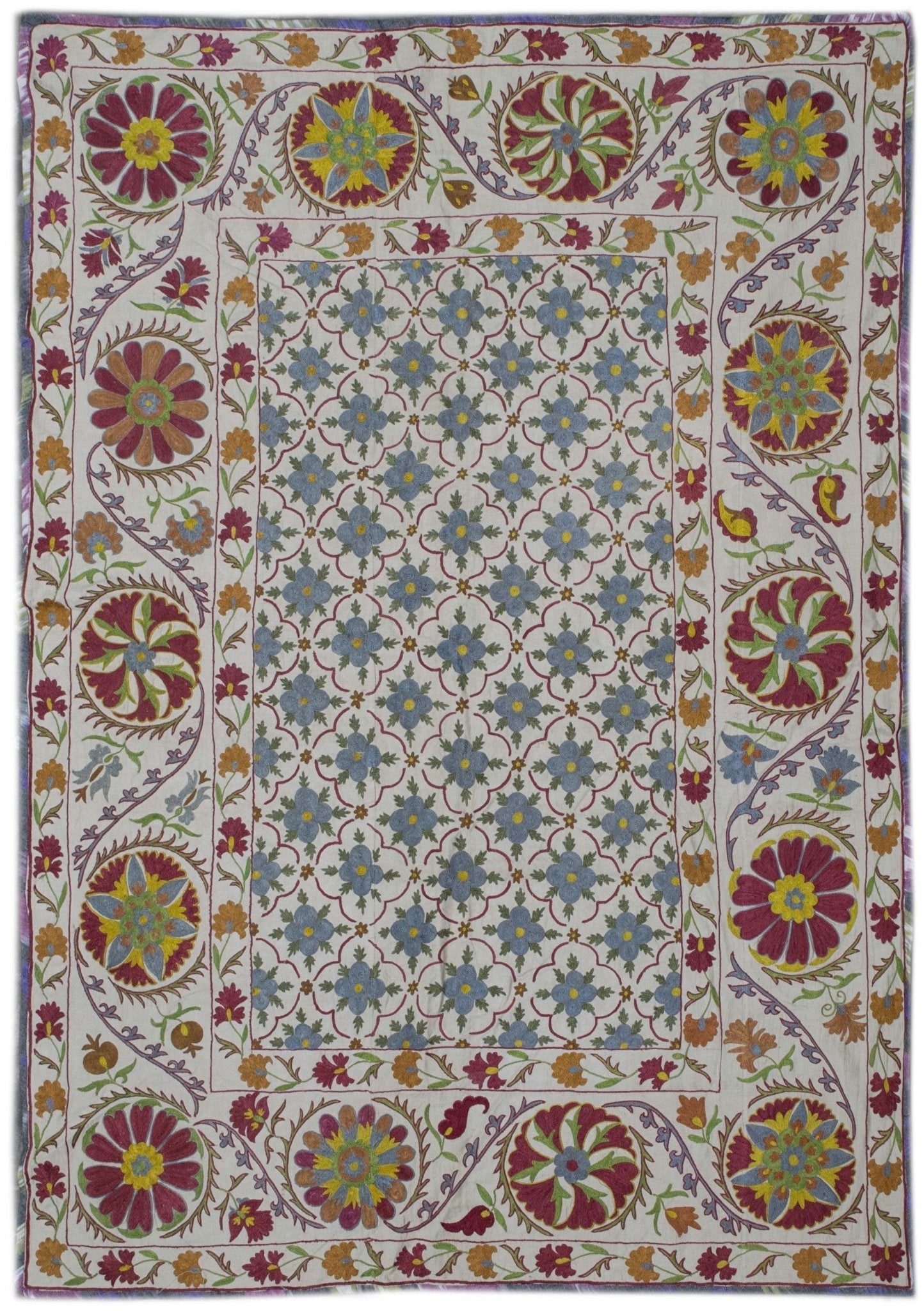 Handmade Uzbek suzani featuring intricate silk floral embroidery on a cream cotton base.