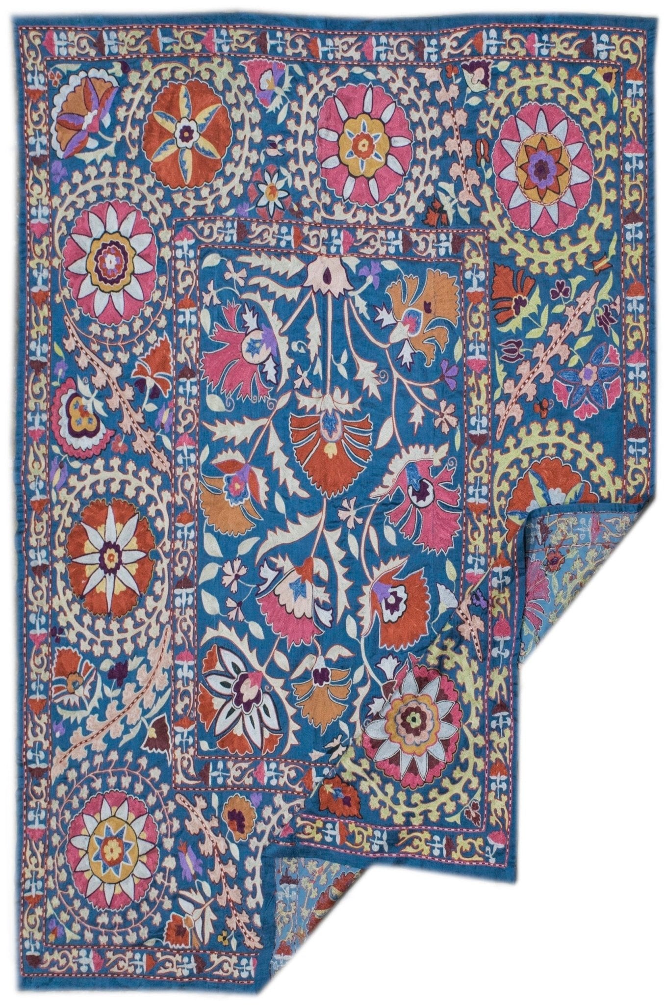 Handmade Uzbek suzani featuring intricate floral silk embroidery on a blue silk fabric base.