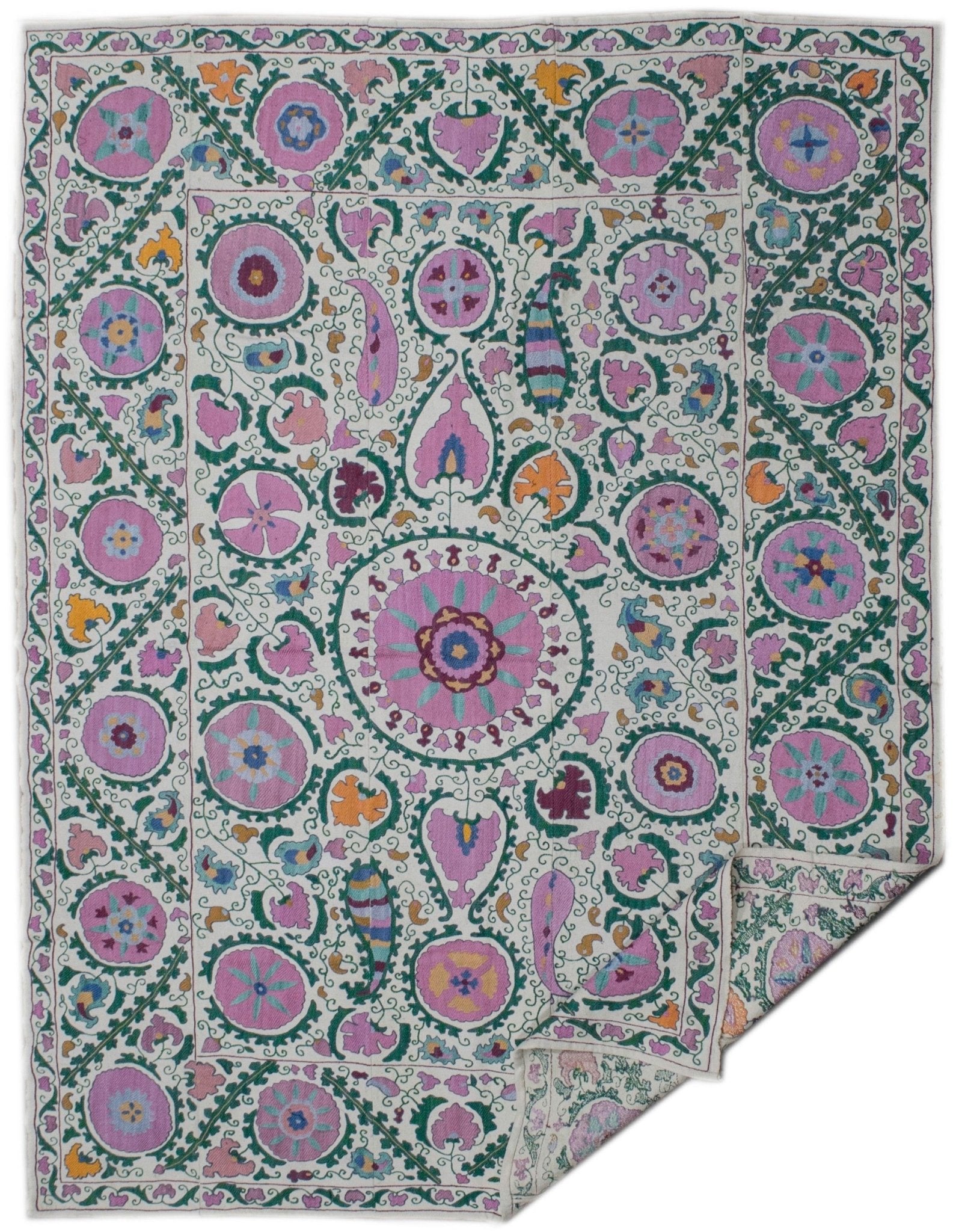 Handmade Uzbek suzani featuring intricate silk floral embroidery on a white cotton base.