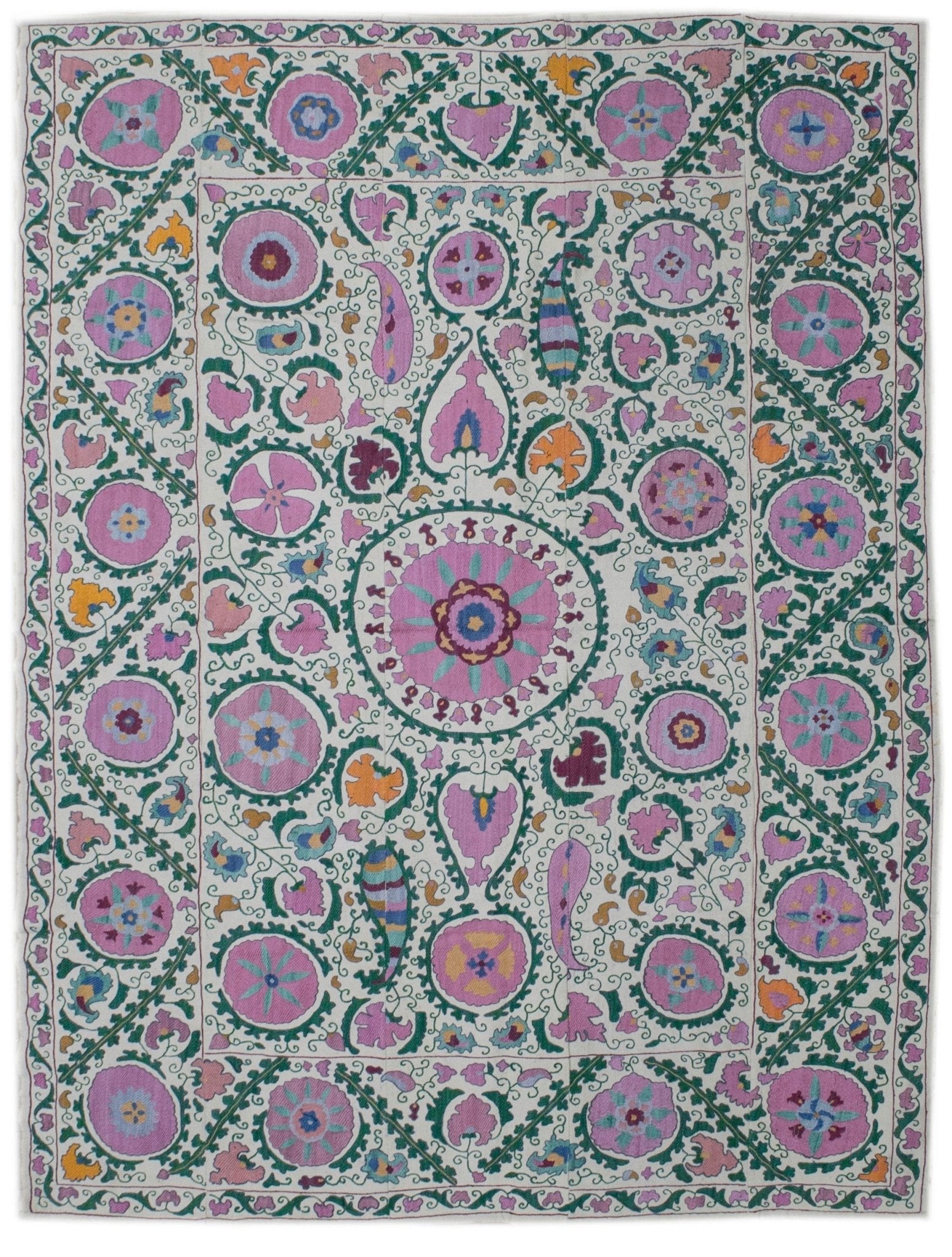 Handmade Uzbek suzani featuring intricate floral silk embroidery on a white cotton base.
