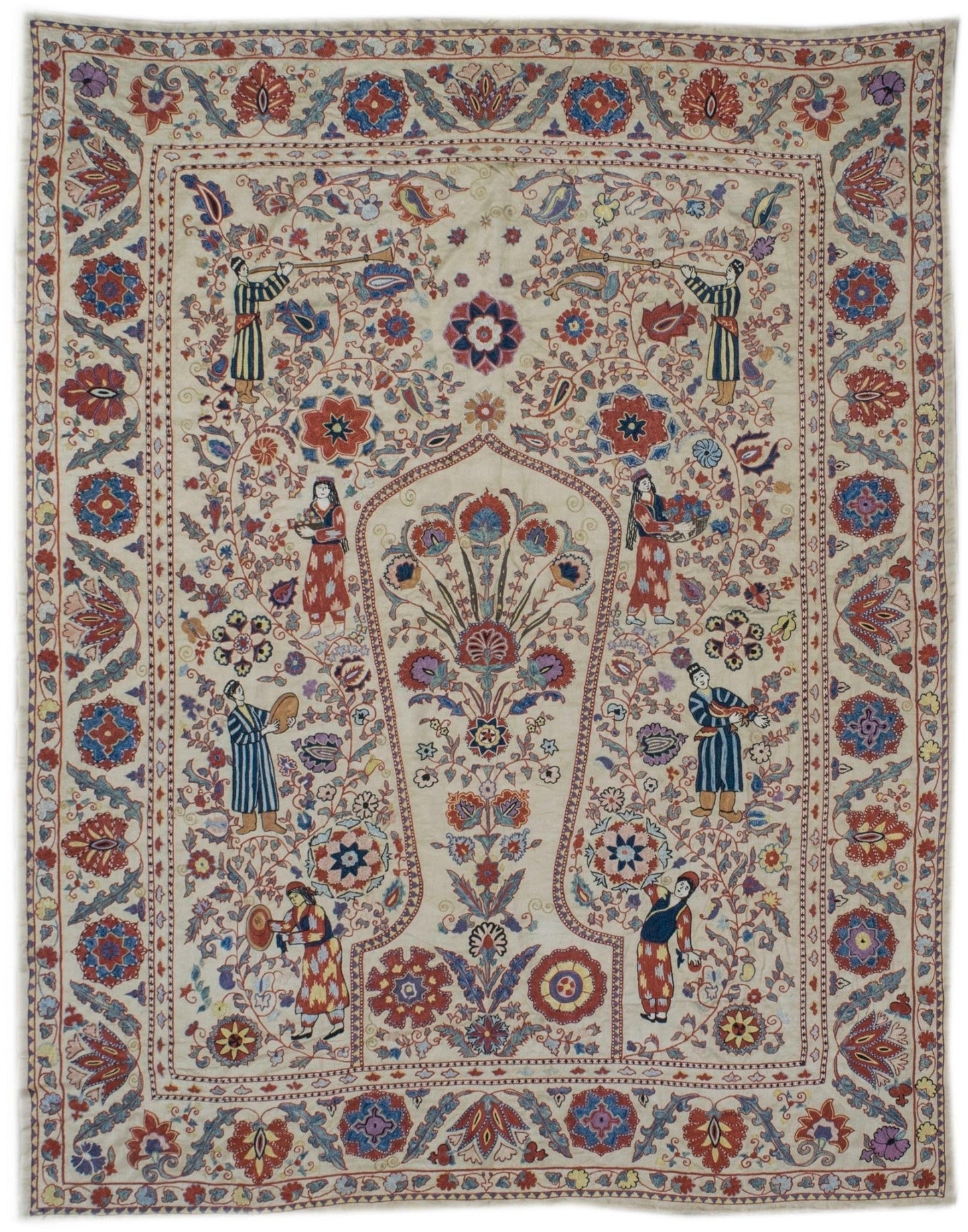 Handmade silk Uzbek suzani featuring intricate floral embroidery and figures on a cream background.