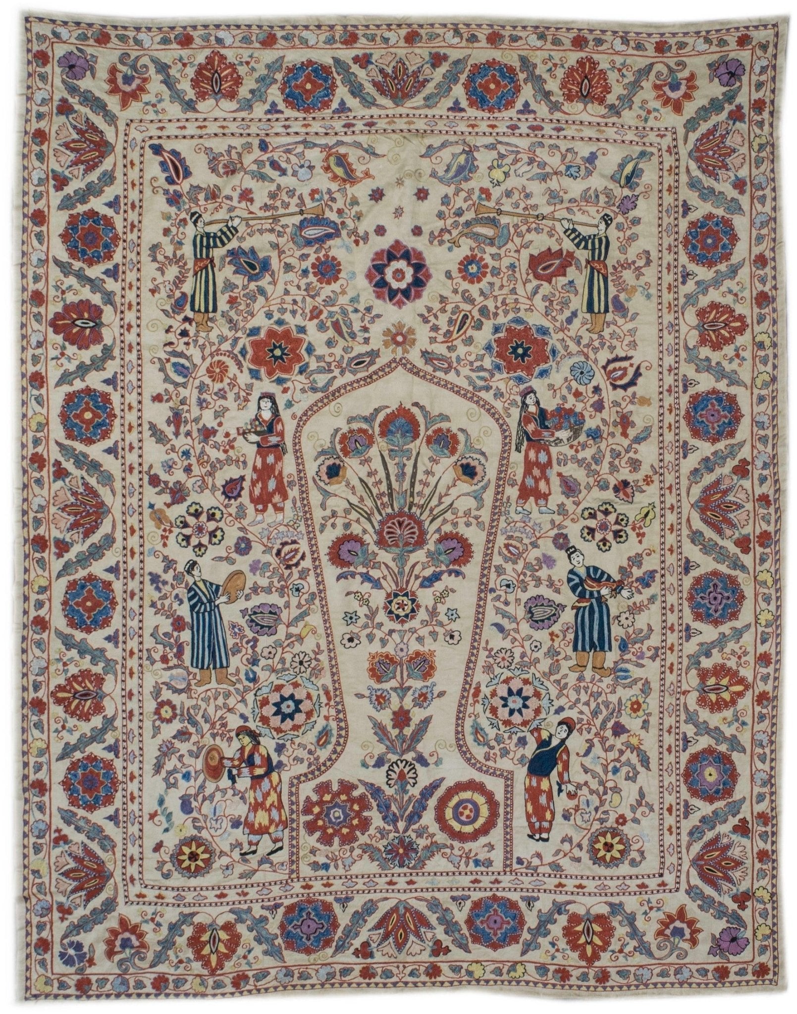 Handmade silk Uzbek suzani featuring intricate floral embroidery and figures on a cream background.