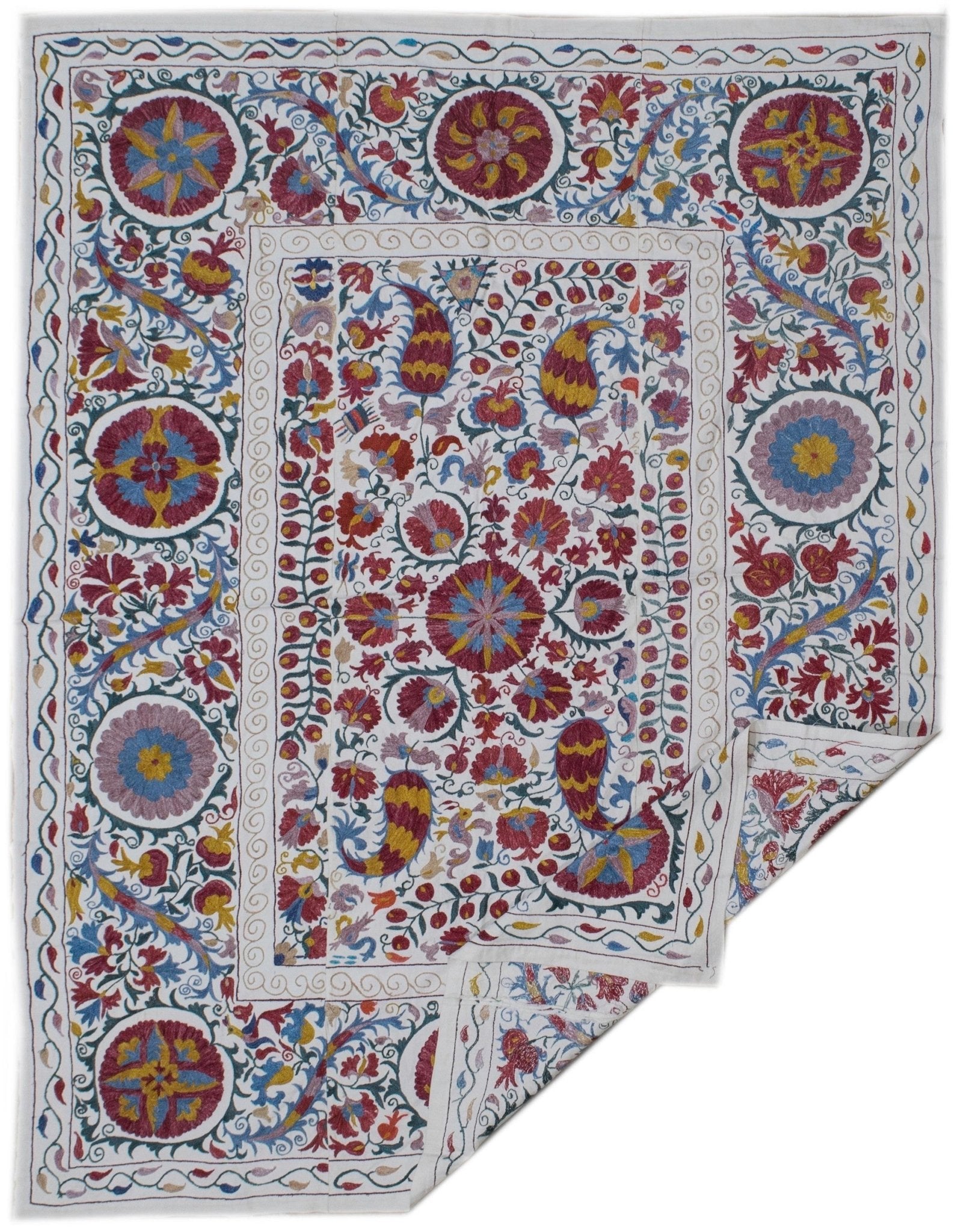Handmade Uzbek suzani featuring intricate silk floral and paisley embroidery on a cotton base.