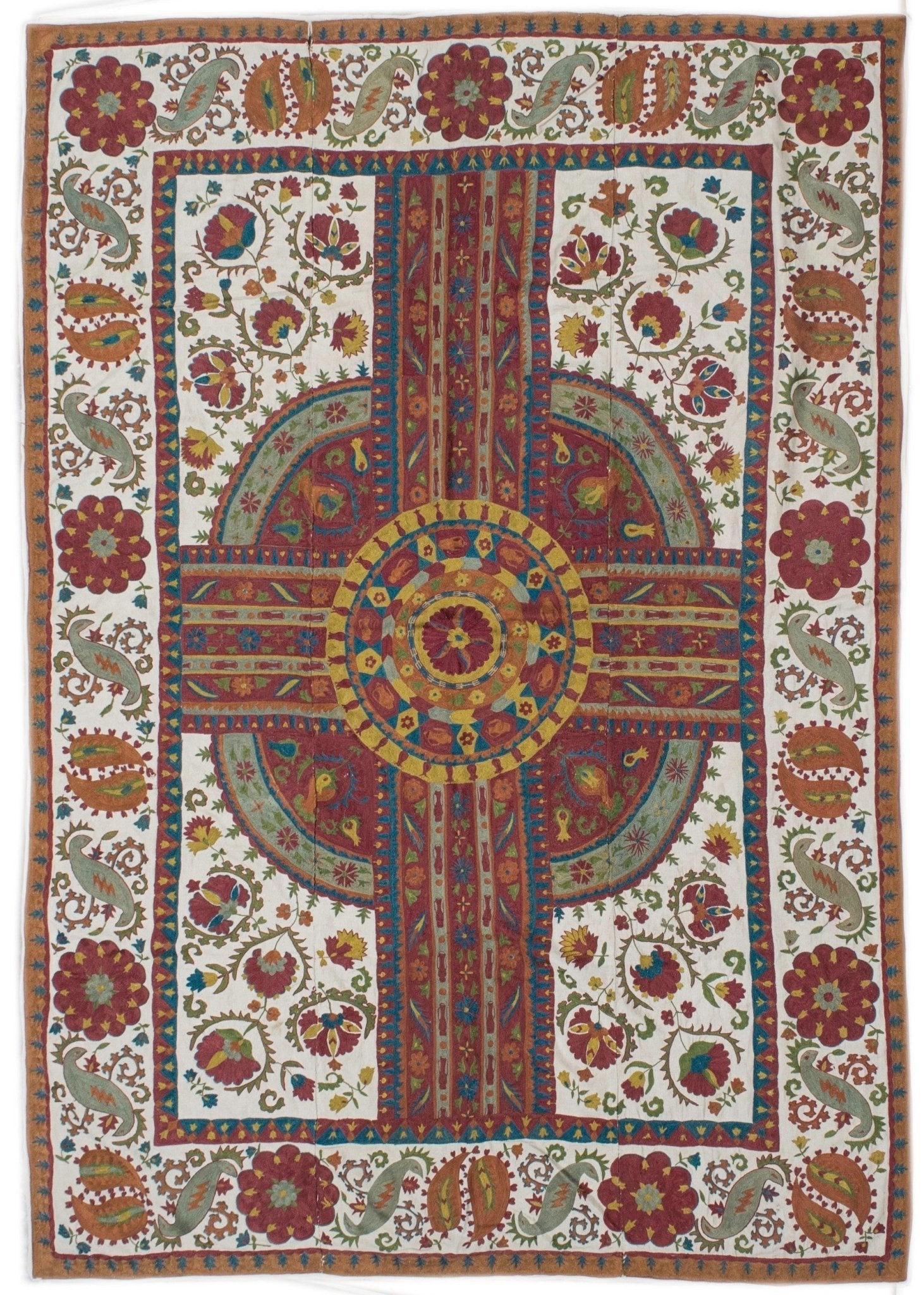 Handmade Uzbek suzani featuring intricate silk floral and paisley embroidery on a cotton base.