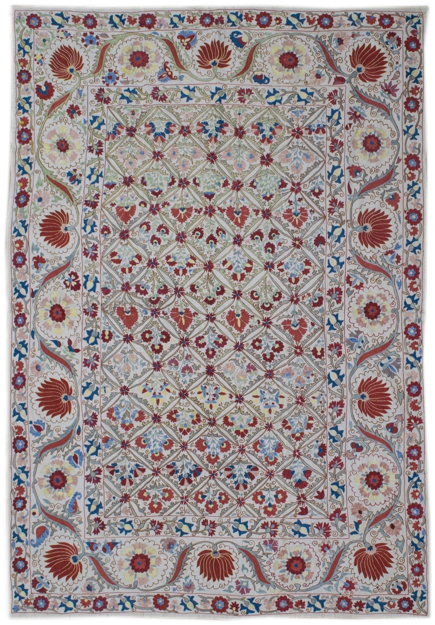 Handmade Uzbek suzani featuring intricate floral silk embroidery on a white cotton base.