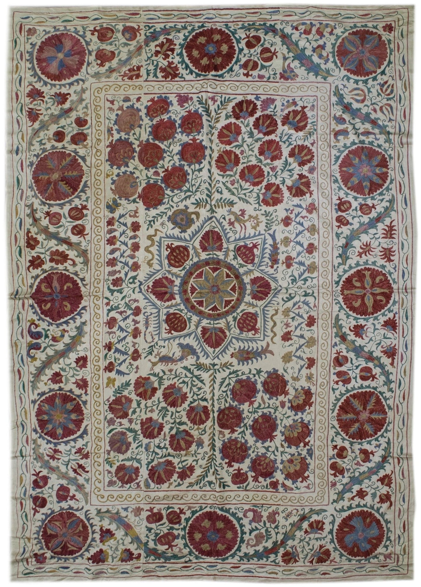 Handmade Uzbek suzani featuring intricate silk floral and pomegranate embroidery on silk fabric.