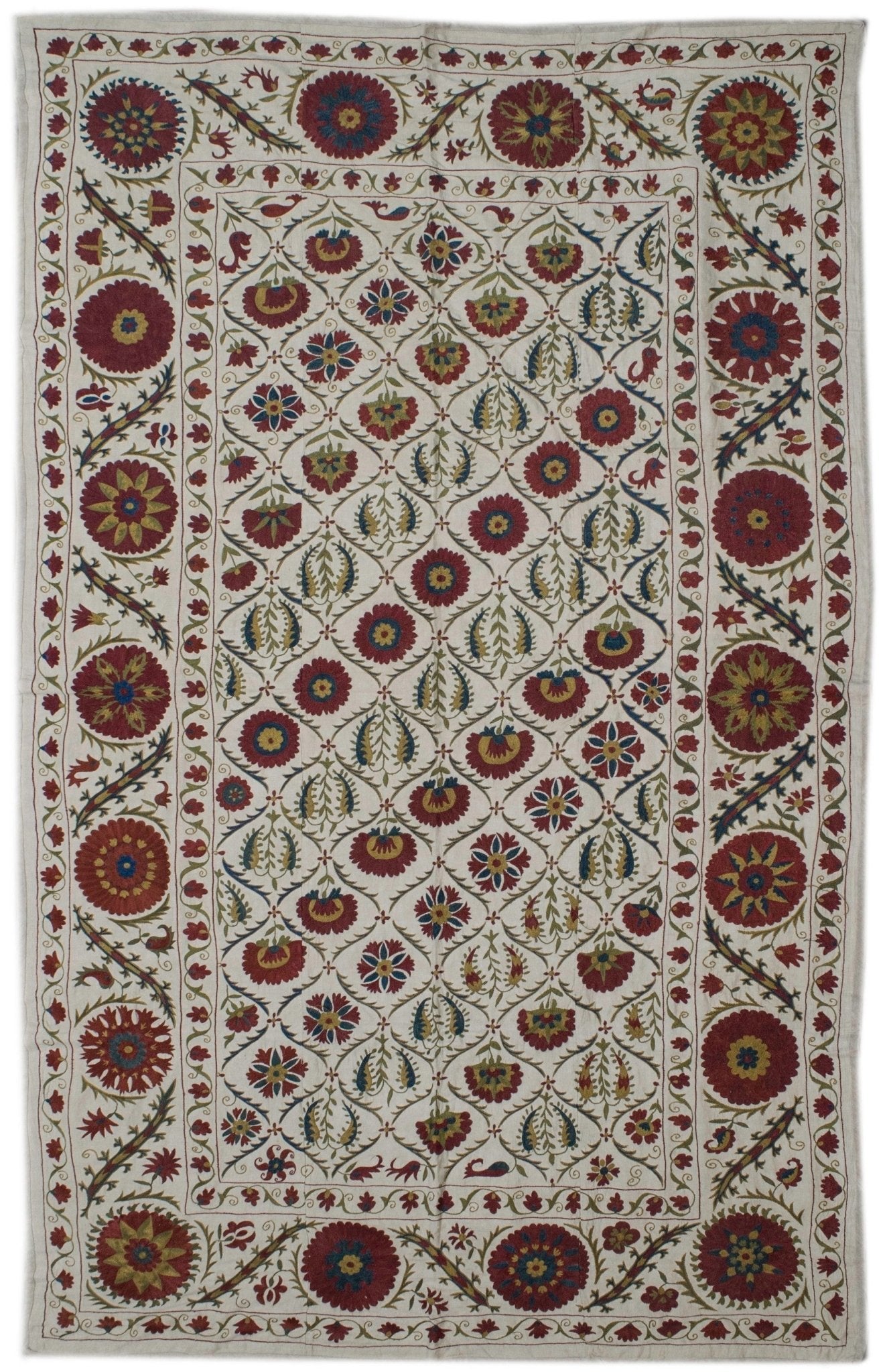 Handmade Uzbek suzani featuring intricate silk floral embroidery on a white cotton base.