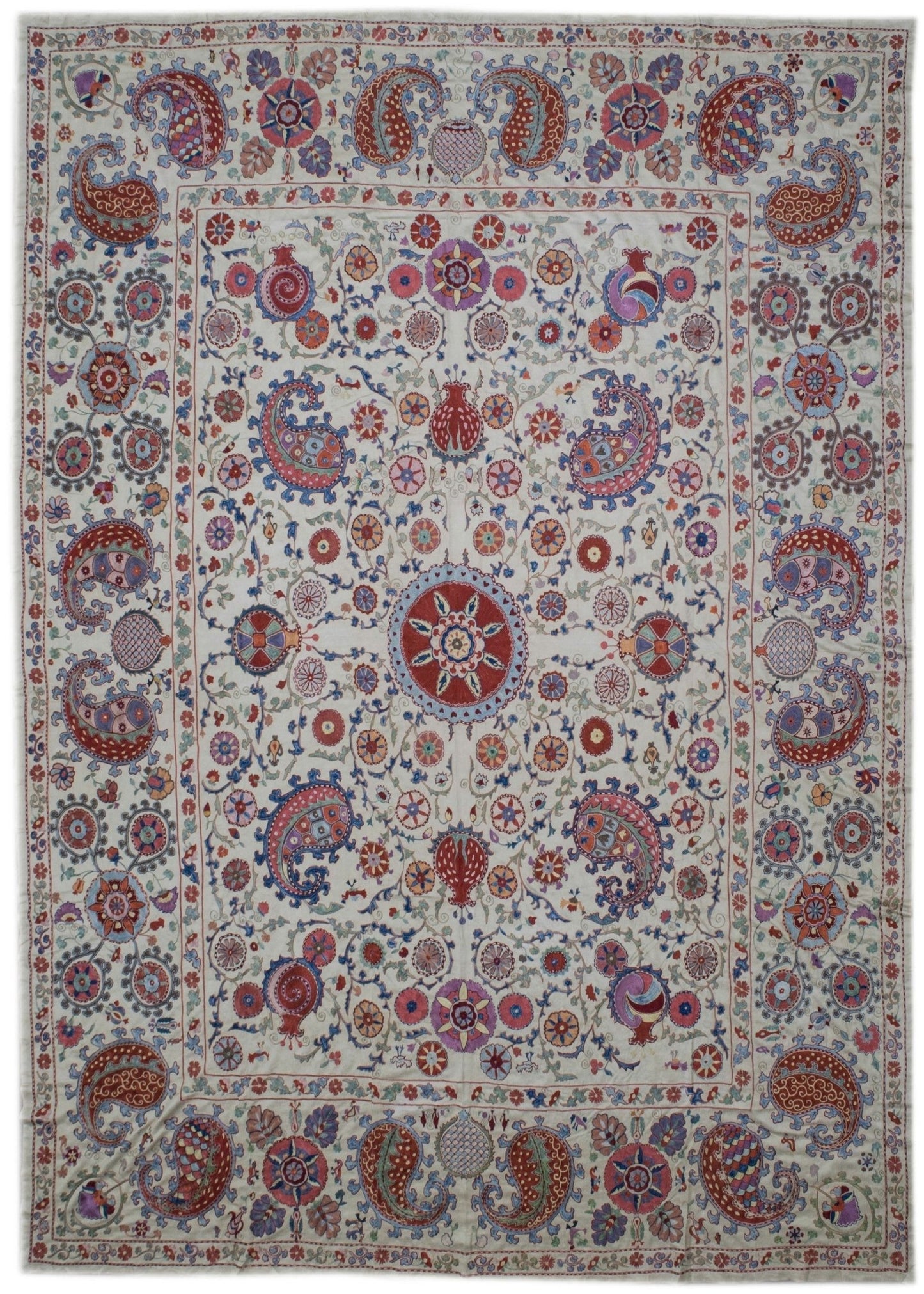 Handmade Uzbek suzani featuring intricate silk floral and paisley embroidery on a silk base.